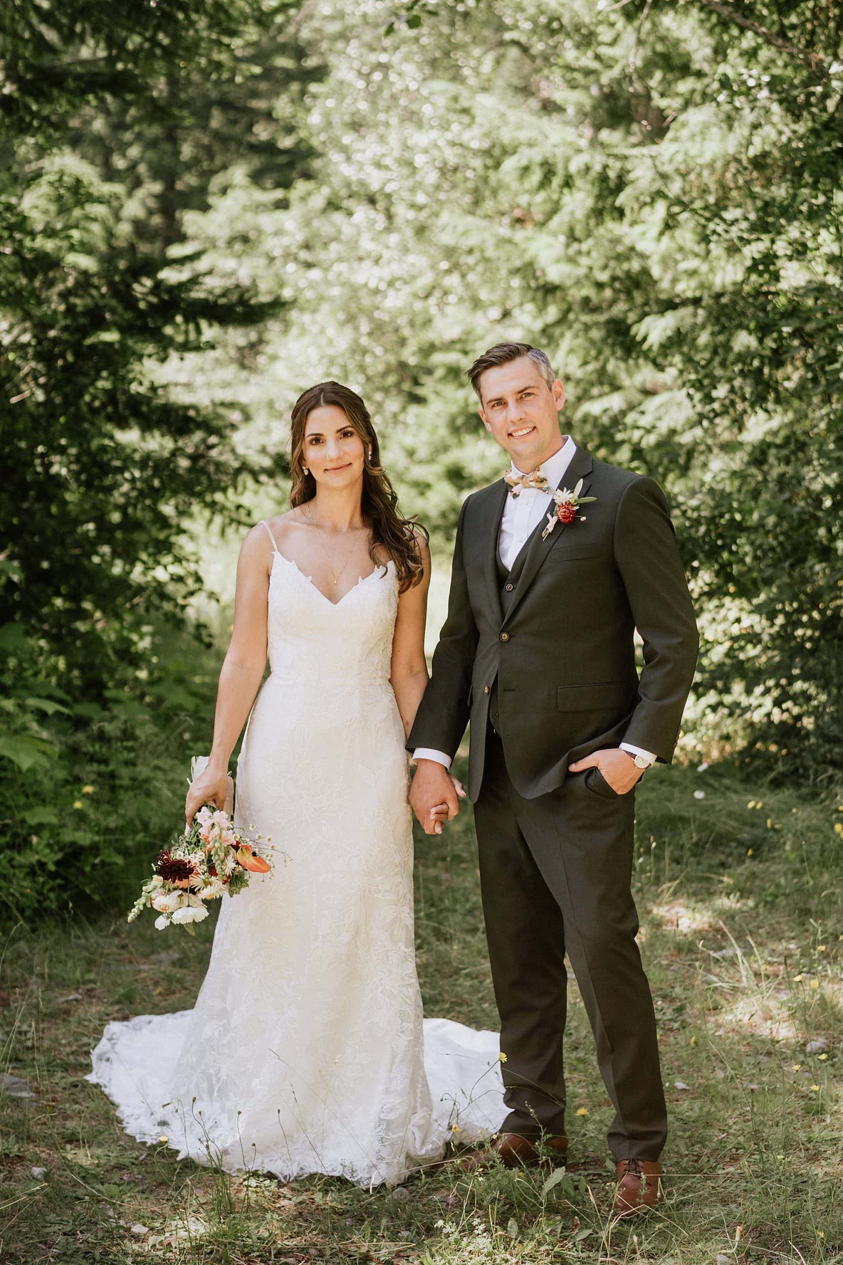 North-Arm-Farm-Wedding_0016 A bride and groom standing in the woods captured by a Squamish wedding photographer.