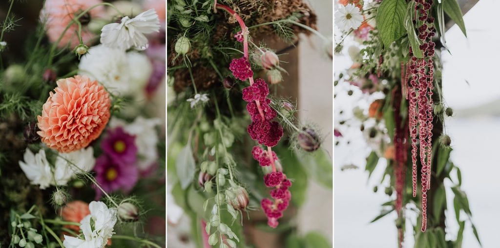 Close-up view of assorted colorful flowers, including orange dahlias, pink blooms, and greenery arranged in a natural bouquet.